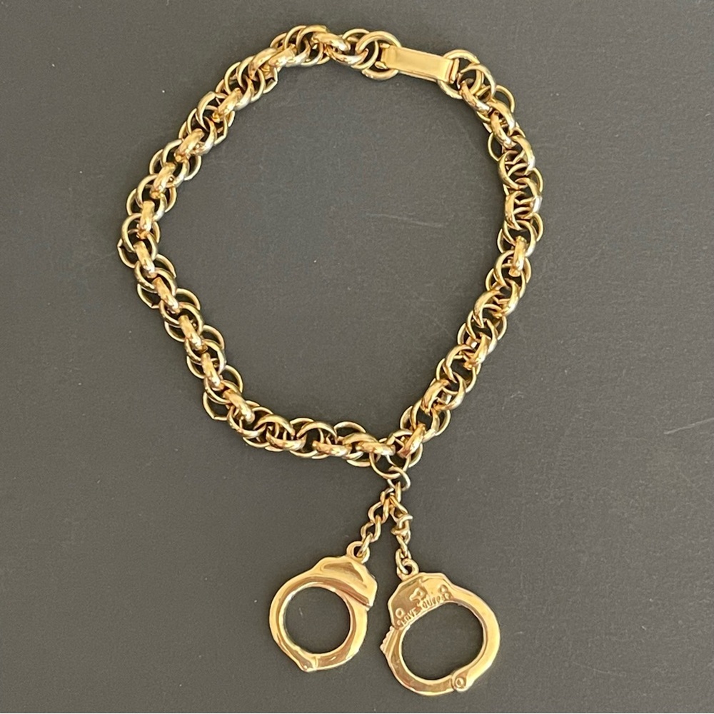 Gold tone Bracelet with Handcuff Charm.